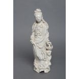 A CHINESE BLANC DE CHINE PORCELAIN FIGURE modelled as a female deity wearing a beaded bodice, her