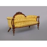 A VICTORIAN WALNUT SHOW FRAME SOFA of curved outline, button upholstered in yellow silk damask,