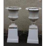 A PAIR OF LARGE VICTORIAN CAST IRON URNS, of lobed and half fluted campana form with tongue and dart
