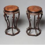 A PAIR OF CHINESE PADOUK WOOD JARDINIERE STANDS, c.1900, the banded burr wood circular top and cloud