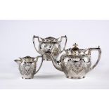 A LATE VICTORIAN SILVER THREE PIECE TEA SERVICE, maker Cooper Bros., Sheffield 1900, of globular