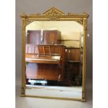 A VICTORIAN GILT GESSO AND EBONISED PIER GLASS, the leaf moulded cornice surmounted by a pediment,