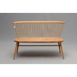 AN ERCOL MODEL 450 LOVE SEAT, 1960's, in beech and elm, with straight top rail, spindle back and
