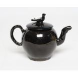 A JACKFIELD BLACK TYPE SMALL TEAPOT AND COVER, mid 18th century, of globular form with crabstock