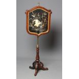 A VICTORIAN ROSEWOOD POLE SCREEN, the leaf carved shield with needlework panel depicting a crane