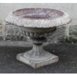 A VICTORIAN CAST IRON GARDEN URN, half fluted campana form, the wide shallow bowl with tongue and