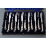 AN EDWARDIAN SET OF SIX PAIRS OF SILVER DESSERT KNIVES AND FORKS, maker Isaac Ellis & Sons,