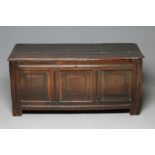 AN OAK PANELLED COFFER, early 18th century, the hinged plank lid with moulded edge, the fascia