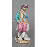 A MEISSEN PORCELAIN FIGURE, late 19th century, modelled as a young boy wearing a plumed peaked