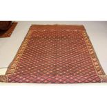 A YOUMET TURKMAN(?) RUG, the madder field with all over trellis pattern in navy blue and ivory,