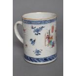 A CHINESE PORCELAIN MUG of plain cylindrical form with pulled handle, lightly moulded with shaped