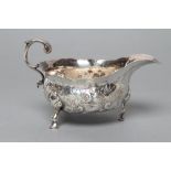 A GEORGE II SILVER SAUCEBOAT, maker possibly Benj, Cartwright, London 1755, of bombe oval form