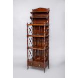 A ROSEWOOD FOUR TIER WHATNOT, early 19th century, of oblong form, the raised back with arched