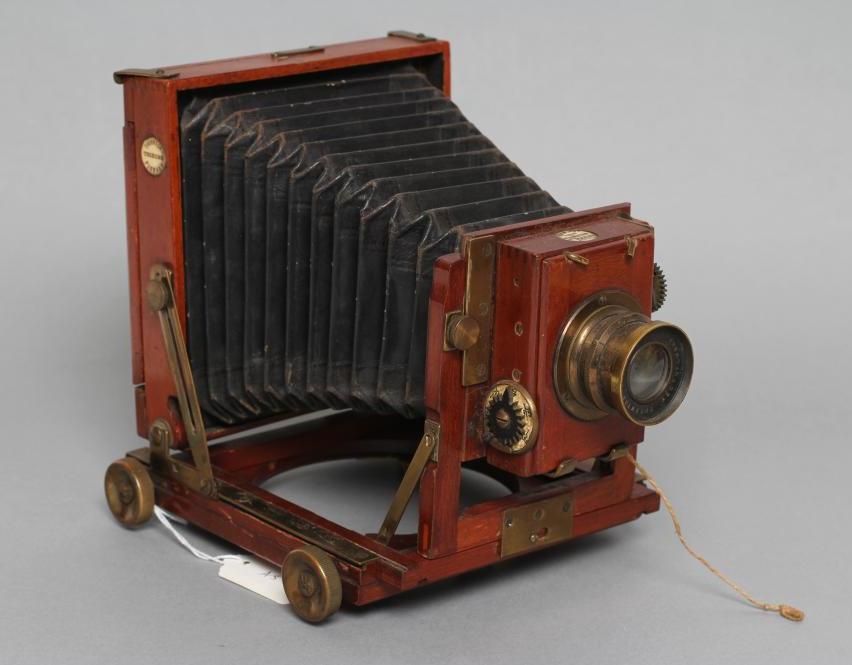 A THORNTON PICKARD "TRIBUNE" FIELD CAMERA of wooden construction with brass fittings and rectoplanat