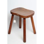 ROBERT THOMPSON, an adzed oak stool, the waisted rounded oblong seat with carved mouse trademark