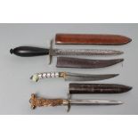 THREE SHEATHED DAGGERS, comprising a possible 19th century naval fighting knife, with double edged 7