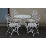 A CAST IRON FOLDING TABLE AND CHAIRS, possibly French 20th century, the scroll pierced circular