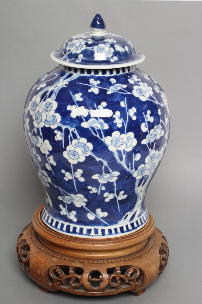 A CHINESE PORCELAIN JAR AND COVER of inverted baluster form, painted in underglaze blue with the