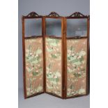 A VICTORIAN WALNUT FOLDING ROOM SCREEN, each part glazed panel with arched leaf and scroll carved