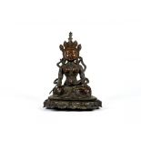 A SINO TIBETAN CAST BRONZE FEMALE DEITY, seated in the dhyanasana pose, holding a kalasa in her left