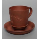 AN ELERS TYPE REDWARE CAPPUCINE AND SAUCER, early 18th century, the slightly flared cylindrical