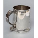 A SILVER MUG, maker's mark rubbed, London 1945, of plain tapering cylindrical form, the loop