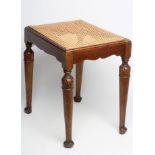 A MAHOGANY DRESSING STOOL, 20th century, of oblong form with drop in carved seat, waved rails,