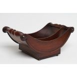A REGENCY MAHOGANY CHEESE COASTER of typical dished form with centre division, the split baluster