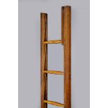 AN OAK POLE LIBRARY LADDER, c.1900, of faceted tapering form with eight rungs, 93 1/2" x 11 3/4" (