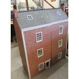 A large Georgian town house style doll's house, built of four stories including the windowed