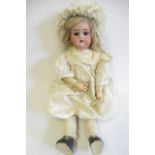 A Kammer & Reinhardt bisque socket head doll, with brown glass sleeping eyes, open mouth, teeth,