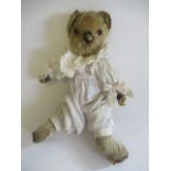 A 1940s teddy "Miss Tilly-pop", with amber eyes, sewn nose, yellow plush, jointed body and cream