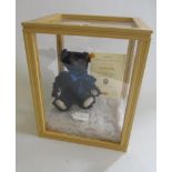 A Steiff Othello bear, serial number 0309, with certificate, ear button and tag, within perspex