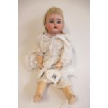 A Kammer & Reinhardt bisque socket head doll, with blue glass sleeping eyes, open mouth, applied top