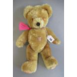 A Farnell growling teddy bear, with amber eyes, orange plush, jointed body, fabric pads and label to