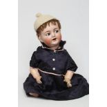 A Kammer & Reinhardt bisque socket head character doll, with blue glass flirty eyes, sleeping