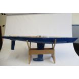 A large radio controlled pond yacht fitted with R.C. equipment and sails, 155cm x 30cm x 50cm,