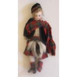 A bisque socket head Scottish boy doll, with blue glass fixed eyes, closed mouth, fabric body with