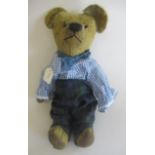 A pre-war teddy, with clear glass eyes, sewn nose, straw filled jointed body, fabric pads,