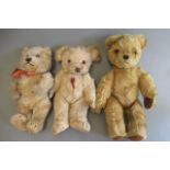 Three vintage bears, comprising a 12" jointed orange plush bear with amber eyes and internal bell, a