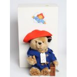 A boxed Steiff Paddington Bear, with blue coat, marmalade sandwich, suitcase and hat