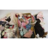 A quantity of dolls clothing and accessories, including hands and wired glass eyes