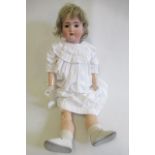 A bisque socket head doll, comprising a Bruno Schmidt girl, with brown glass sleeping eyes,