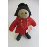 A Paddington Bear, with amber eyes, red felt coat, black felt hat, PB black boots and label, 22"