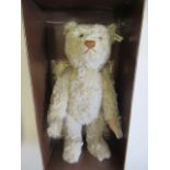 A boxed Steiff British Collector's 1911 replica teddy bear, no. 01298, with light plush, ear button,