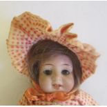 An all bisque miniature mignonette dolls house doll, with brown glass fixed eyes, open mouth, teeth,