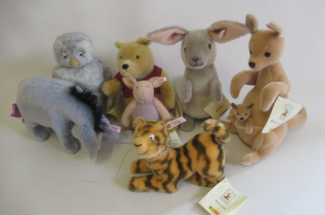 Seven Steiff Winnie the Pooh characters, comprising Owl, Kanga & Roo, Rabbit, Tigger, Eeyore, Piglet