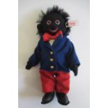 A boxed Steiff "Golly Boy", limited edition, in felt clothing and leather boots with ear button