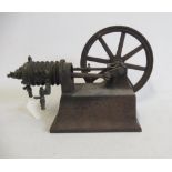 A small hot air engine flywheel and cylinder on cast base, most castings have rust, F