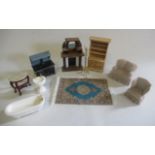 A box of doll's house furniture, including fireplace, dresser, stove/aga, dining table and chairs,